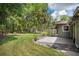 Expansive backyard featuring lush greenery, mature trees, and a concrete patio, perfect for outdoor entertainment at 5607 78Th E Ave, Palmetto, FL 34221