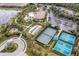 Overhead view of community tennis and bocce ball courts, playground, pool, and parking at 5673 Piccolo St, Nokomis, FL 34275