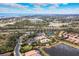 Scenic aerial view showcasing the community pool, tennis courts, surrounding homes and coastal landscape at 5673 Piccolo St, Nokomis, FL 34275