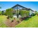 Manicured backyard showing the screened-in pool area with manicured hedges offering privacy at 5673 Piccolo St, Nokomis, FL 34275