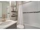 Well-lit bathroom featuring a vanity with a quartz countertop and a shower/tub with a white shower curtain at 5673 Piccolo St, Nokomis, FL 34275