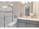 Well-lit bathroom with a glass-enclosed shower and quartz countertop vanity at 5673 Piccolo St, Nokomis, FL 34275