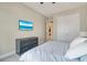 Bedroom with a TV, matching dresser, and closet, offering a cozy space at 5673 Piccolo St, Nokomis, FL 34275