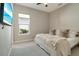 Bedroom featuring a comfortable bed with decorative pillows and a window at 5673 Piccolo St, Nokomis, FL 34275