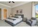 Bright bedroom offers a queen bed, soft carpet, and modern art at 5673 Piccolo St, Nokomis, FL 34275