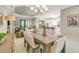 Spacious dining room area offers a seamless transition to a bright living room and kitchen at 5673 Piccolo St, Nokomis, FL 34275
