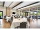 Elegant event room with large windows, hardwood floors, and tables set for a special occasion at 5673 Piccolo St, Nokomis, FL 34275