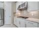 Well-equipped kitchen featuring stainless steel appliances, granite countertops, and white cabinetry at 5673 Piccolo St, Nokomis, FL 34275