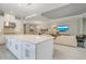Open concept kitchen with large center island, granite countertops, stainless steel appliances, and pendant lighting at 5673 Piccolo St, Nokomis, FL 34275