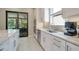 Bright kitchen with modern stainless steel appliances and granite counters, open to screened in patio at 5673 Piccolo St, Nokomis, FL 34275