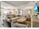 Open-concept living room is complete with a modern sectional sofa and a beautiful dining area at 5673 Piccolo St, Nokomis, FL 34275