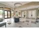 Bright lobby area with tile flooring, elegant chandelier and welcoming seating at 5673 Piccolo St, Nokomis, FL 34275