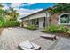 Outdoor space with cornhole boards and a covered structure with a built-in grill at 5673 Piccolo St, Nokomis, FL 34275