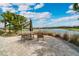 Patio area with a table and chairs overlooking a lake at 5673 Piccolo St, Nokomis, FL 34275