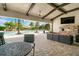 Relaxing outdoor lounge with an outside fireplace and tropical landscaping by the community pool at 5673 Piccolo St, Nokomis, FL 34275