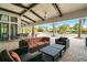 Relaxing outdoor pool patio featuring comfortable seating and shaded areas with lush tropical landscaping at 5673 Piccolo St, Nokomis, FL 34275