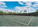 Green tennis court under a sunny sky at 5673 Piccolo St, Nokomis, FL 34275