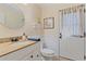 Bathroom with granite counter, under-sink storage, and a door leading to the exterior at 5766 Forester Pine Ct, Sarasota, FL 34243