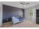 Cozy bedroom with light blue toddler bed, dark accent wall and a ceiling fan at 5766 Forester Pine Ct, Sarasota, FL 34243
