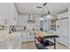 Bright kitchen with white cabinets, granite countertops and updated appliances, including range and stainless vent hood at 5766 Forester Pine Ct, Sarasota, FL 34243