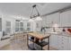 Bright kitchen featuring white cabinets, a breakfast nook, and modern appliances at 5766 Forester Pine Ct, Sarasota, FL 34243