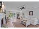 Bright living room with wood flooring, neutral furniture, and a cozy fireplace at 5766 Forester Pine Ct, Sarasota, FL 34243