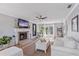 Bright living room with wood flooring, neutral furniture, and a cozy fireplace at 5766 Forester Pine Ct, Sarasota, FL 34243
