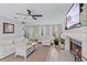 Bright living room featuring a fireplace, ceiling fan, and neutral decor at 5766 Forester Pine Ct, Sarasota, FL 34243