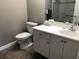 Bathroom with a toilet and vanity with a white sink and cabinet at 5767 Avista Dr # 5767, Sarasota, FL 34243
