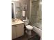 Bathroom with a toilet, vanity with sink, and a glass door enclosed shower at 5767 Avista Dr # 5767, Sarasota, FL 34243