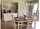 Open dining area with a cute coffee bar, decor, wooden table and chairs, and hardwood floors at 5767 Avista Dr # 5767, Sarasota, FL 34243