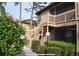 Charming condo with wood stairs, nice landscaping, and flowering bushes on a sunny day at 5767 Avista Dr # 5767, Sarasota, FL 34243
