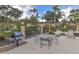 Community outdoor grilling area with seating and lounge chairs by the hot tub at 5767 Avista Dr # 5767, Sarasota, FL 34243