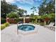 Outdoor hot tub surrounded by lush landscaping and lounge chairs for relaxation in a garden-like setting at 5767 Avista Dr # 5767, Sarasota, FL 34243