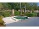 Exterior shot of an inviting outdoor hot tub surrounded by landscaping and a concrete patio at 5767 Avista Dr # 5767, Sarasota, FL 34243