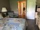 Relaxing main bedroom with accent chair, comfy queen bed, and a view of the en suite at 5767 Avista Dr # 5767, Sarasota, FL 34243