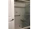 Modern glass-enclosed shower featuring sleek fixtures, tile surround, and convenient seating at 5767 Avista Dr # 5767, Sarasota, FL 34243