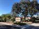 Avista community sign with mature oak trees, well manicured landscaping, and blue sky background at 5767 Avista Dr # 5767, Sarasota, FL 34243