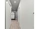 Hallway view of a modern bathroom featuring a white vanity and sleek fixtures at 5838 Meriwether Pl, Sarasota, FL 34232