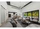 Bright, modern living room featuring high ceilings, pool view, and open layout to the kitchen at 5838 Meriwether Pl, Sarasota, FL 34232