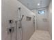 Luxurious shower features dual shower heads, built-in niche, and modern gray tiling at 5838 Meriwether Pl, Sarasota, FL 34232