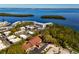 Aerial view showcasing the property with surrounding lush greenery and waterfront scenery at 605 Sutton Pl # 401-A, Longboat Key, FL 34228