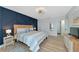 Bright bedroom boasts a modern accent wall and en-suite bath at 605 Sutton Pl # 401-A, Longboat Key, FL 34228