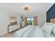 Bedroom features a dresser with a TV and serene water view at 605 Sutton Pl # 401-A, Longboat Key, FL 34228