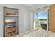 Cozy bedroom with sliding glass doors to balcony, closet, and TV stand with storage at 605 Sutton Pl # 401-A, Longboat Key, FL 34228
