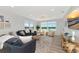 Bright living room with waterfront views, light wood flooring, and stylish coastal decor at 605 Sutton Pl # 401-A, Longboat Key, FL 34228