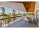 Relaxing covered balcony featuring a dining table, chairs, and tropical views at 612 Fern St, Anna Maria, FL 34216