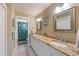 Bathroom featuring double sinks with granite counters and a shower/tub combo at 612 Fern St, Anna Maria, FL 34216