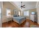 Comfortable bedroom featuring a ceiling fan, wood floors, and soothing decor at 612 Fern St, Anna Maria, FL 34216