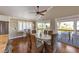Dining room with seating for six, hardwood floors, sliding glass doors and views of the outdoor deck at 612 Fern St, Anna Maria, FL 34216